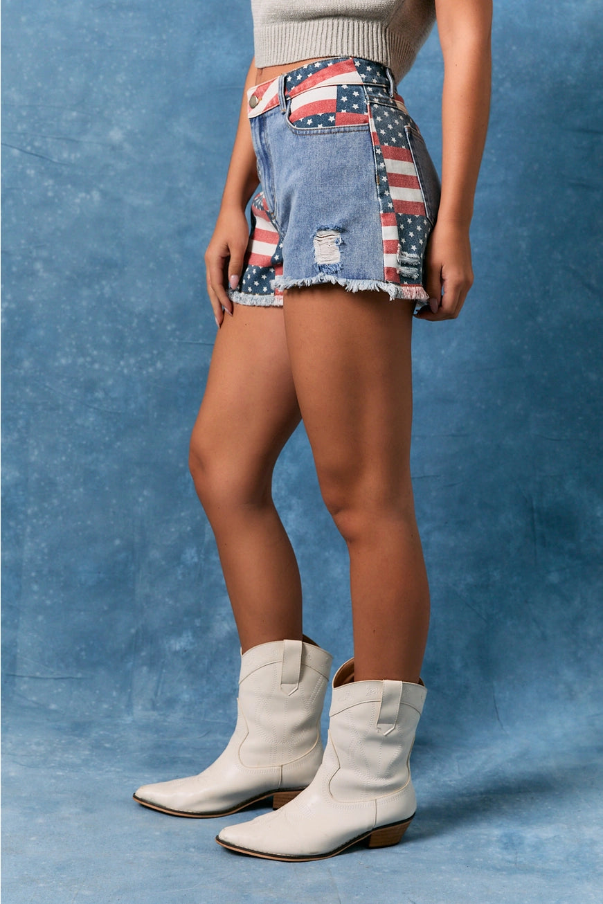 American Flag patchwork denim shorts by Le Lis featuring a stylish patchwork design and frayed hem, casual summer shorts.