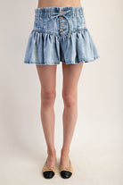 Ruffle flared denim mini skirt with elastic waist from RARA Boutique, featuring ruffle details and a stylish, casual design.