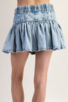 RARA Boutique DELETE ruffle flared denim mini skirt with elastic waist, showing the stylish ruffle hem and fitted waist detail.