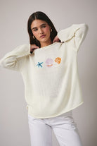 RARA Boutique Coastal Seashell lightweight knit sweater in soft fabric, featuring seashell patterns and a cozy fit.