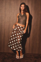 Mid-wisted polka dot bias skirt by LE LIS, featuring a flowy fabric and classic pattern, shown on a model.
