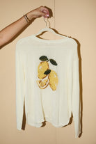 RARA Boutique lemon graphic lightweight knit sweater featuring a vibrant lemon print on soft fabric.