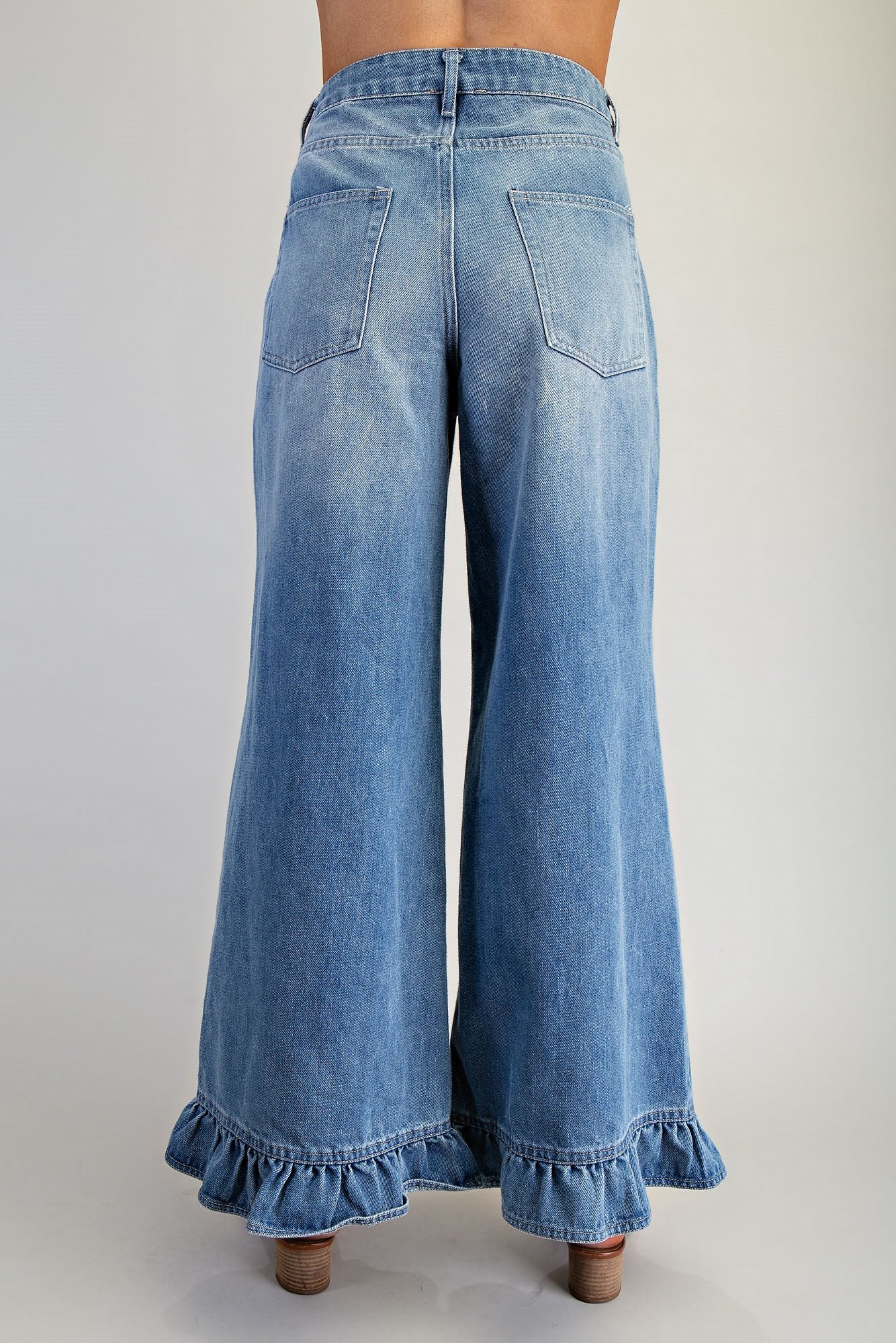 Ruffle hem wide-leg mineral washed jeans by RARA Boutique, featuring a relaxed fit and stylish ruffle details at the hem.