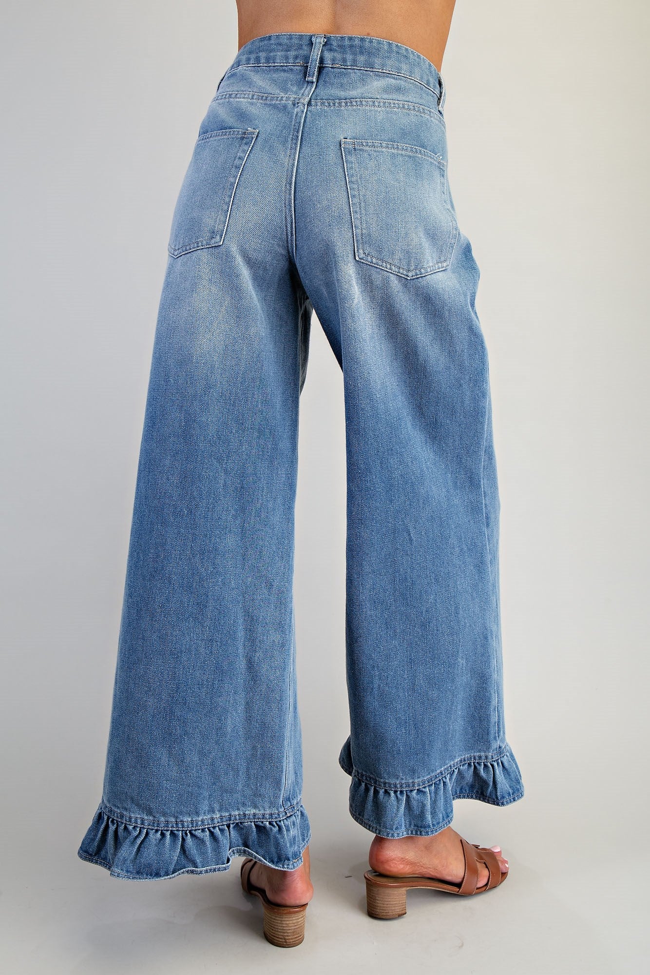 Ruffle hem wide leg mineral washed jeans by RARA Boutique featuring a relaxed fit and distressed details.