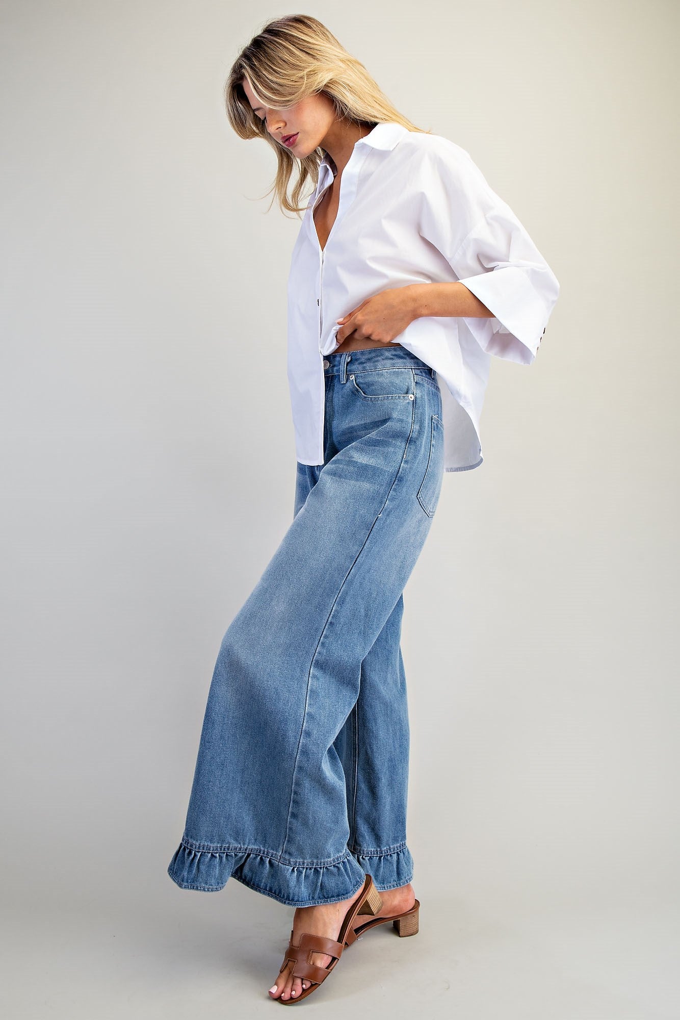 Ruffle hem wide-leg mineral washed jeans by RARA Boutique, featuring a relaxed fit and stylish ruffle detail at the hem.