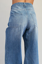 Ruffle hem wide-leg mineral washed jeans by RARA Boutique, showcasing relaxed fit and stylish ruffle details.