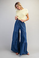 RARA Boutique mineral washed denim palazzo pants with tiered wide-leg design, styled for a relaxed and trendy look.