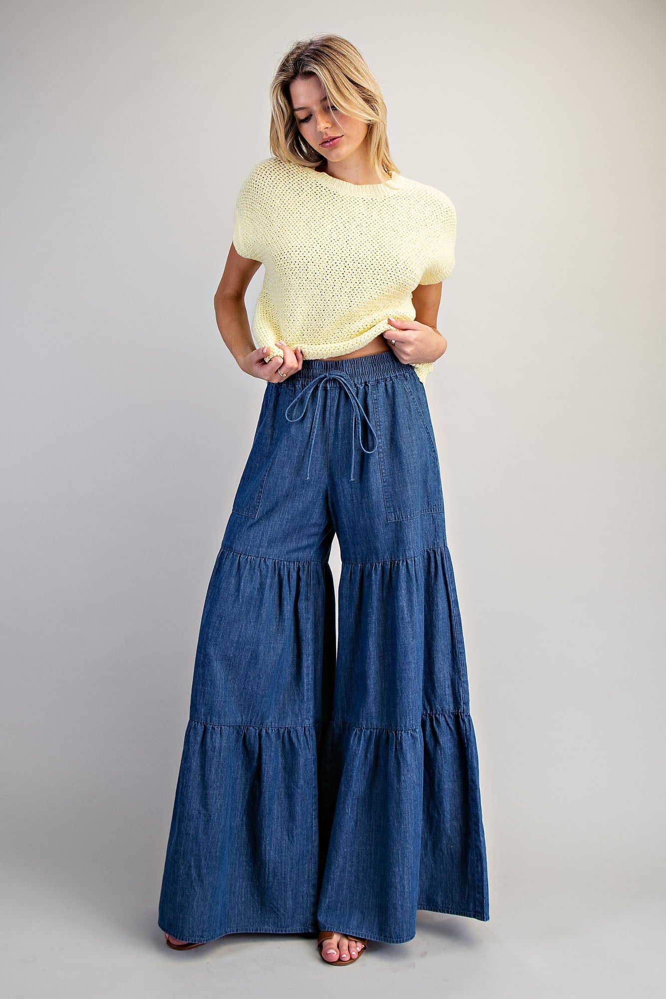 RARA Boutique mineral washed denim palazzo pants with tiered wide-leg design, styled with a relaxed fit and casual vibe.