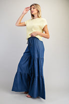 RARA Boutique mineral washed denim palazzo pants with a tiered ultra-wide leg design, relaxed fit, and stylish casual look.