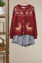 Mello Reindeer Fair Isle knit cardigan featuring festive reindeer and snowflake patterns in warm winter colors.