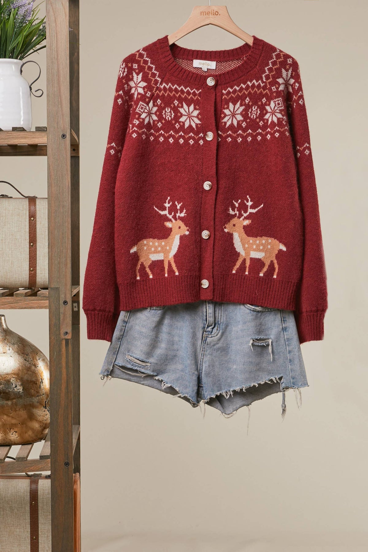 Mello Reindeer Fair Isle knit cardigan featuring festive reindeer and snowflake patterns in warm winter colors.