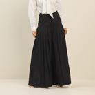 Light beige pleated ultra wide-leg cotton trousers from RARA Boutique, featuring a relaxed fit and high waist design.