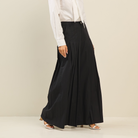Light beige pleated ultra-wide leg cotton trousers from RARA Boutique, showcasing a relaxed fit and high waist design.