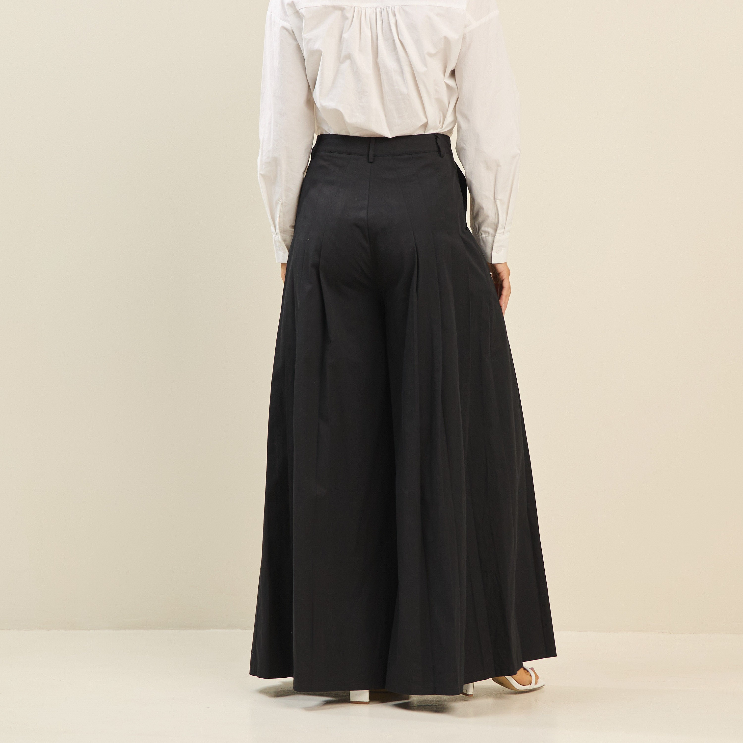 Light beige pleated ultra-wide leg cotton trousers by RARA Boutique, shown with a relaxed fit and stylish pleats.