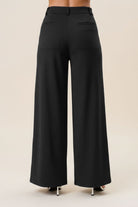 Black high waist tailored wide-leg trousers from RARA Boutique, showcasing the structured fit and elegant design.