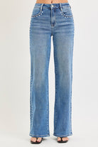 Medium wash Risen studded wide-leg high-rise jeans with belt loops and distressed details, styled with a casual look.
