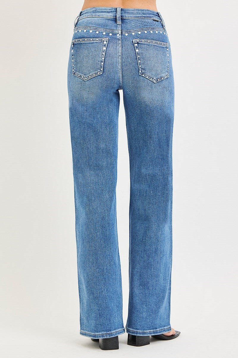 Medium wash Risen studded wide-leg high-rise jeans with belt loops and distressed details, styled with a casual fashion look.