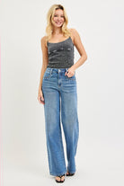 Medium wash Risen studded wide leg high rise jeans with belt loops and distressed details, showcasing a trendy denim style.