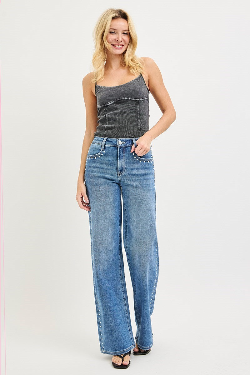 Medium wash Risen studded wide leg high rise jeans with belt loops and distressed details, showcasing a trendy denim style.