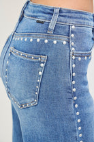 Medium wash Risen studded wide leg high-rise jeans with belt loops and front pockets, showcasing trendy denim style.