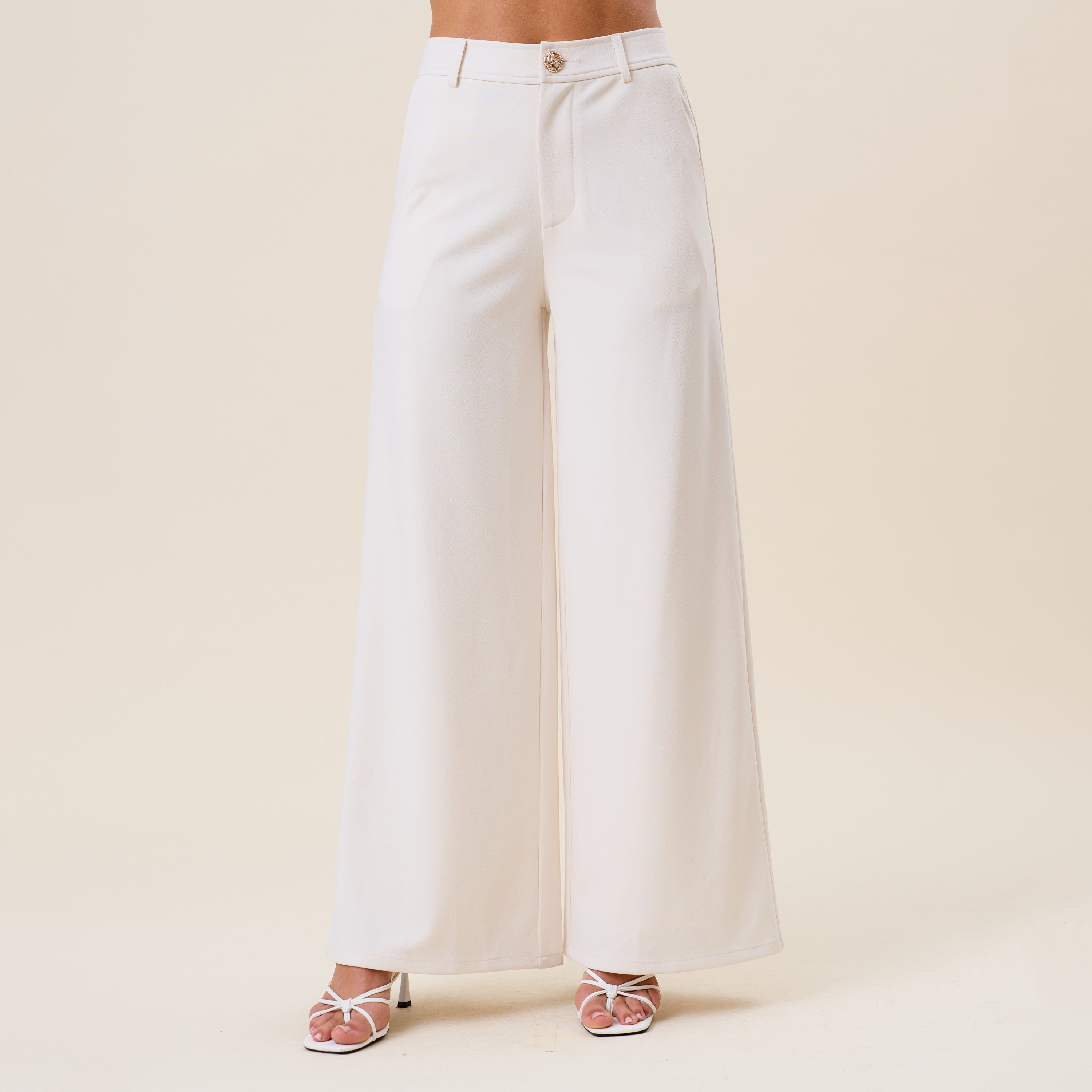High waist tailored wide-leg trousers by RARA Boutique, featuring a sleek fit and classic design in neutral fabric.