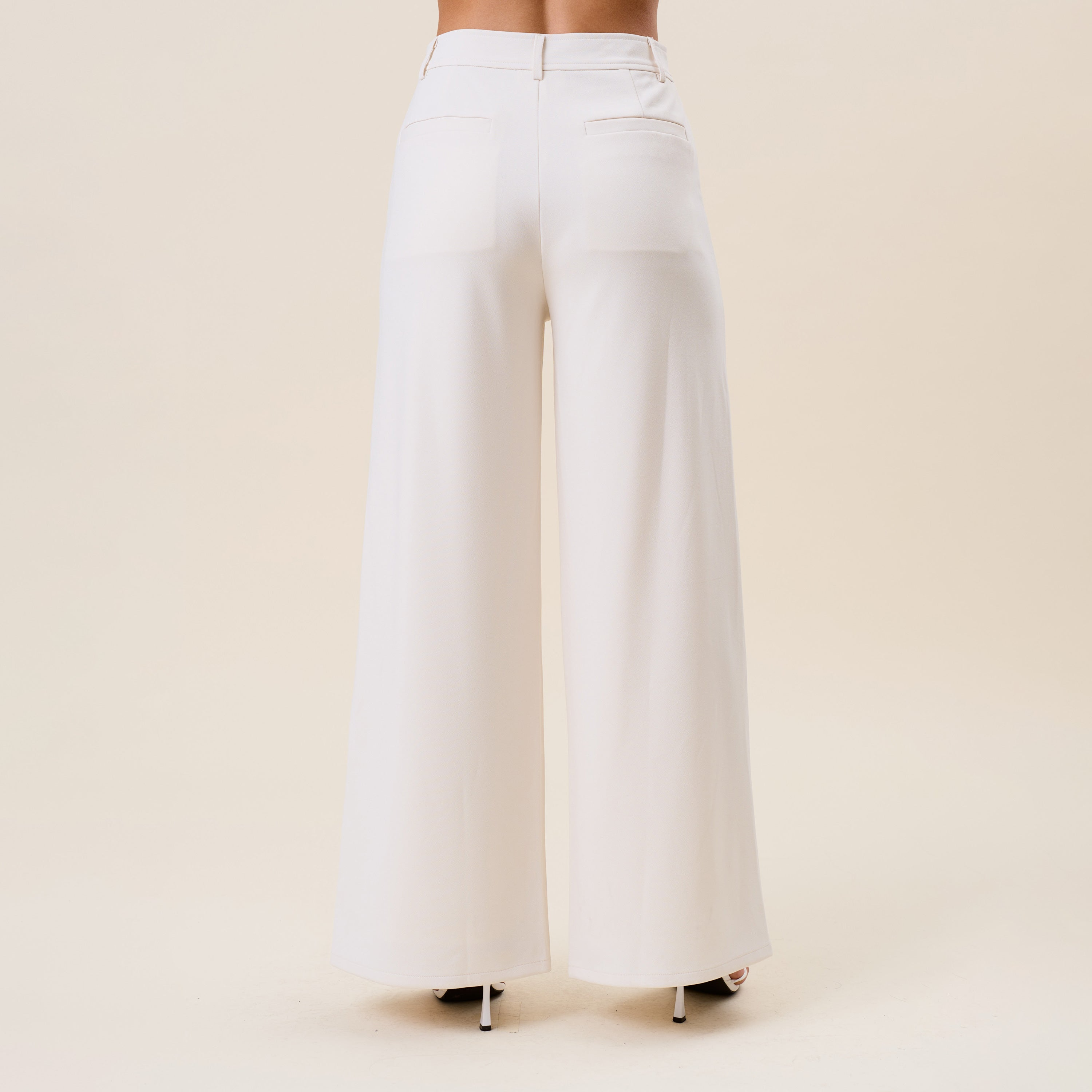High waist tailored wide-leg trousers by RARA Boutique, featuring a sophisticated fit and classic design in neutral fabric.