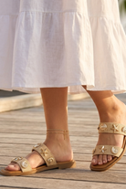 RARA Boutique nautical seashell charm double strap slide sandals, casual summer footwear with seashell accents and comfortable design.