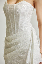 Strapless sequin glitter mesh corset mini dress with draped skirt by RARA Boutique, featuring shiny sequins and a fitted silhouette.