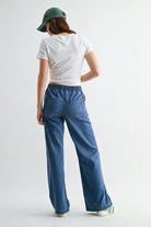 Lightweight denim jogger pants with elastic waist from RARA Boutique, shown in a casual fit with rolled cuffs.