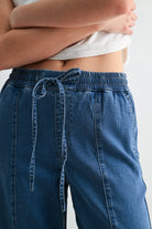 Lightweight denim jogger pants with elastic waist from RARA Boutique, showing front view with relaxed fit and casual style.