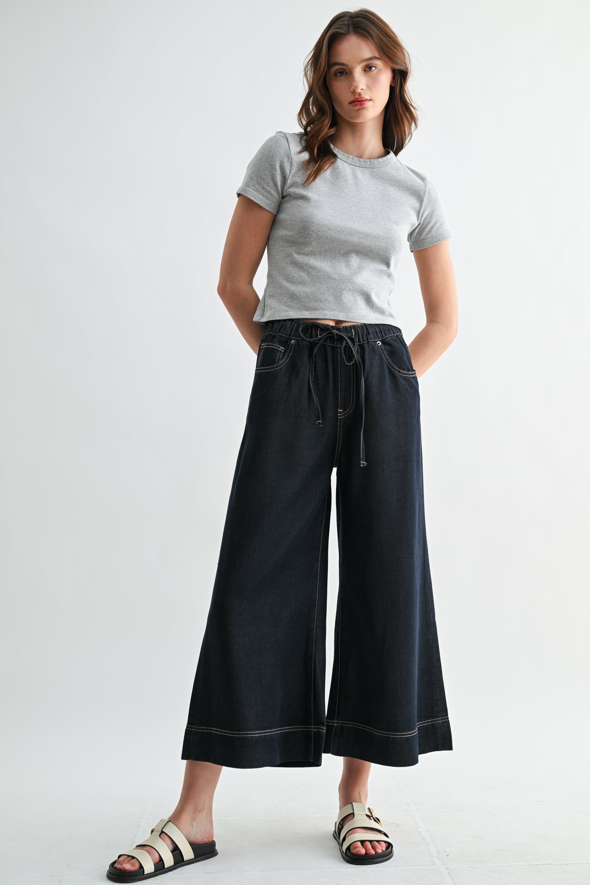 Pair of RARA Boutique wide leg high rise cropped denim-look jogger pants in light blue denim fabric.