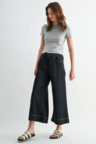 High rise cropped denim-look jogger pants by RARA Boutique, featuring wide legs and a relaxed fit in a stylish denim finish.