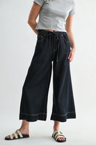 Light blue wide-leg high-rise cropped denim-look jogger pants by RARA Boutique, styled with rolled cuffs and functional pockets.