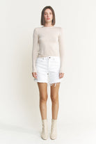 Mid-thigh length high rise raw hem denim shorts from RARA Boutique, featuring a stylish raw hem and classic blue denim.