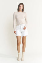 Mid-thigh high rise raw hem denim shorts by RARA Boutique, featuring distressed raw edges and classic blue denim fabric.