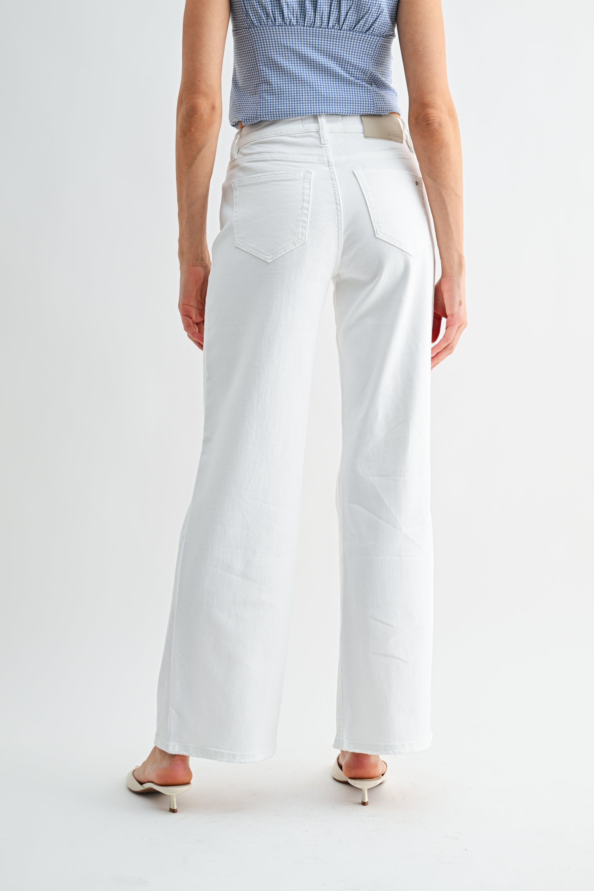 Distressed mid-rise wide-leg jeans by RARA Boutique featuring a relaxed fit and faded wash, displayed on a white background.