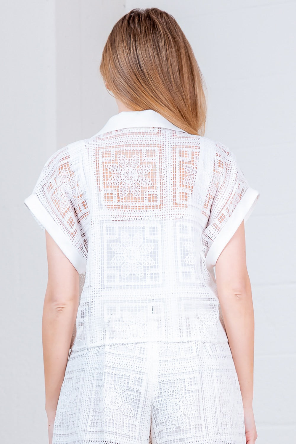 RARA Boutique floral crochet button-down collared blouse with intricate patterns and lightweight fabric, displayed on a hanger.