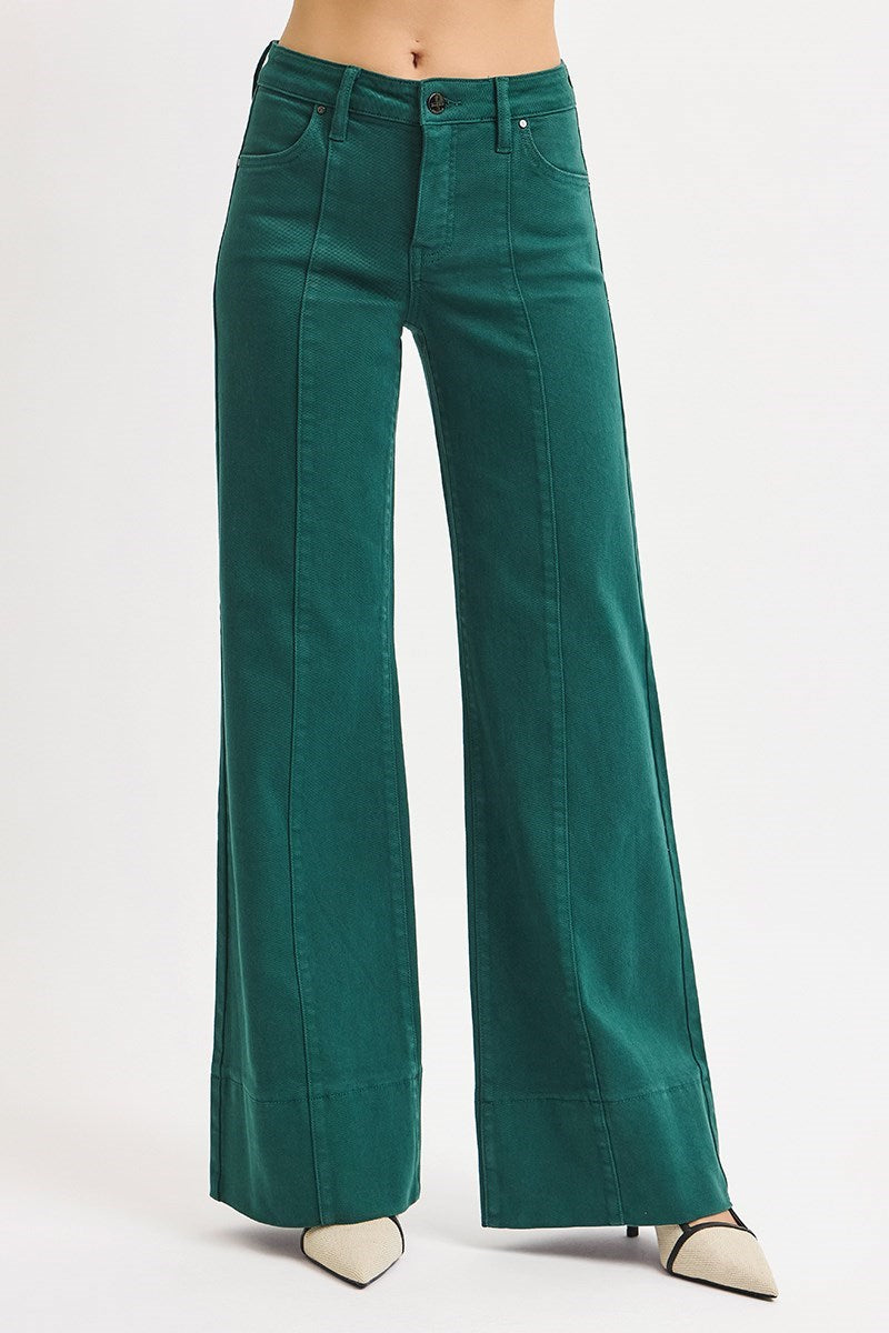 Risen Tummy Control Mid Rise Pin Tuck Wide Leg Jeans with Wide Hem in Hunter Green, featuring a fitted waist and relaxed wide-leg style.
