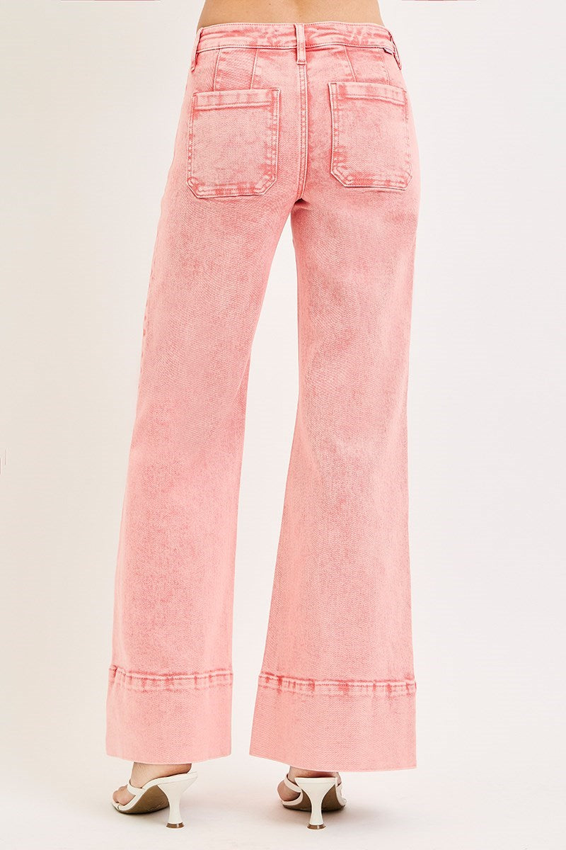 Mineral washed Risen mid-rise wide leg jeans with front seams, styled with casual tops and accessories.
