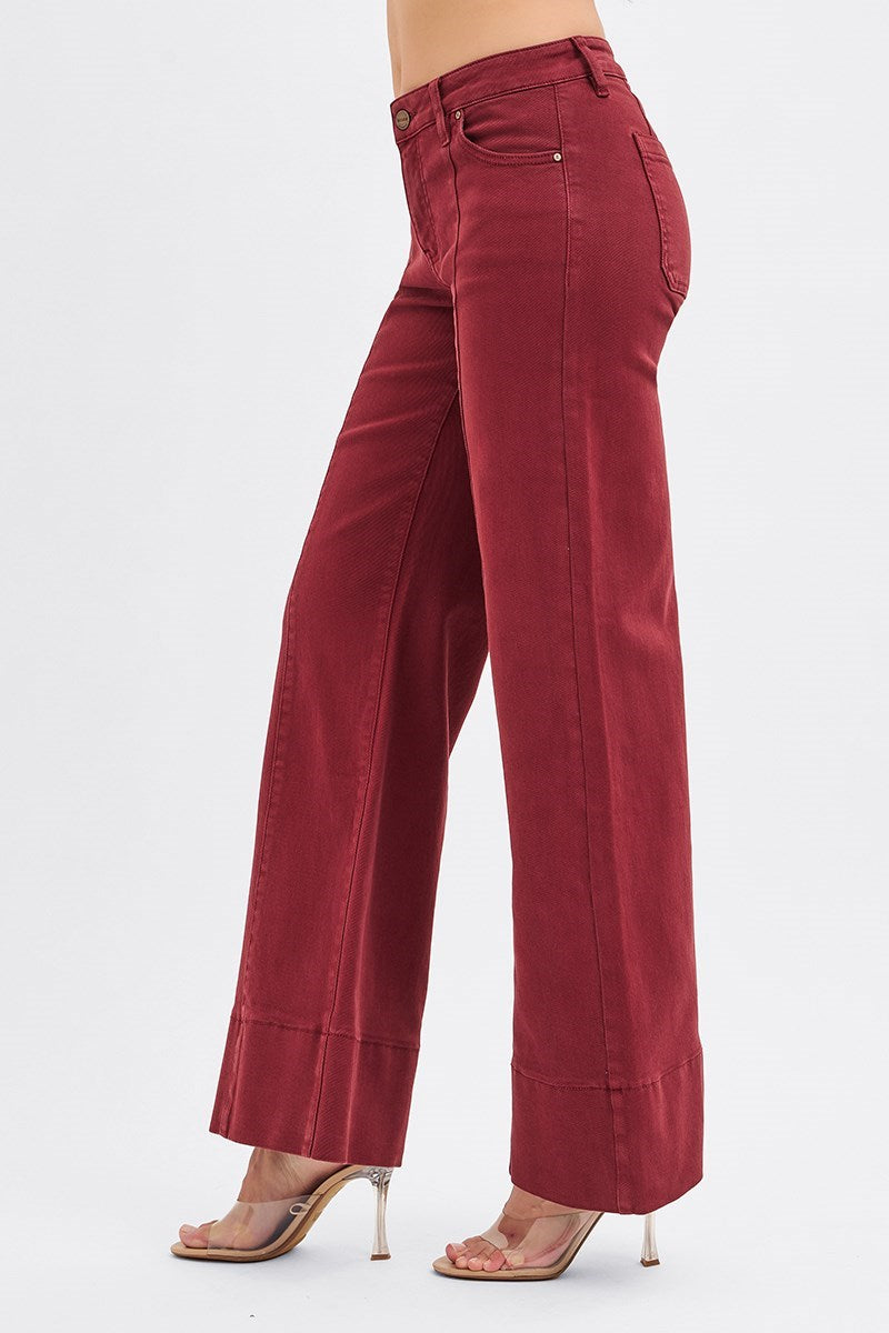 RARA Boutique wine-colored tummy control mid-rise pin tuck wide-leg jeans with wide hem, styled with a natural pose.