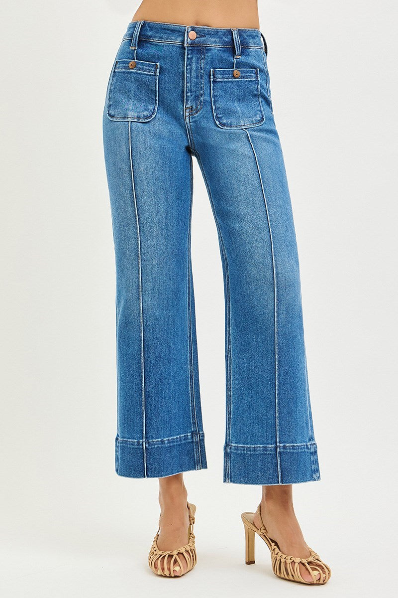 Medium rinse Risen pintuck square patch pocket wide-leg cropped jeans showing front view with patch pockets and relaxed fit.