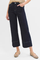 Dark wash Pintuck Tummy Control wide-leg cropped jeans with wide hem from RARA Boutique, showcasing a relaxed fit and stylish design.