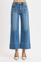 Medium wash Risen pintuck tummy control wide leg cropped jeans with wide hem, stylish and comfortable denim for casual wear.