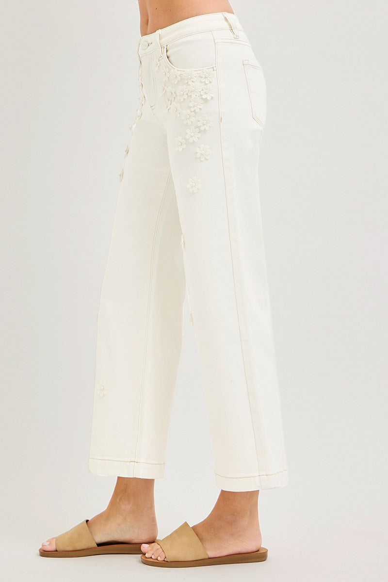Cream wide-leg cropped jeans with 3D flower and pearl embellishments by Risen, showcasing a stylish, modern denim design.
