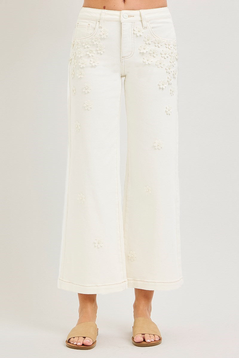 Cream wide-leg cropped jeans by Risen with 3D flower and pearl embellishments, featuring a relaxed fit and stylish details.