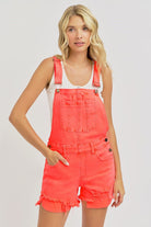 Distressed coral denim overalls by Risen, featuring adjustable straps, front pockets, and a casual, trendy fit.