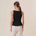 Able Tuesday Top AT3189 ruffle rib-knit tank top with layered ruffles and fitted ribbed fabric, shown on a white background.
