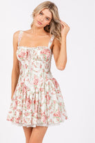 Ivory pink floral corset drop-waist A-line mini dress by RARA Boutique, featuring a fitted bodice and flowy skirt.