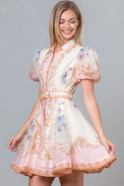 RARA Boutique Baroque scrollwork floral mini dress in baby pink with pearl belt, showcasing intricate design and elegant style.