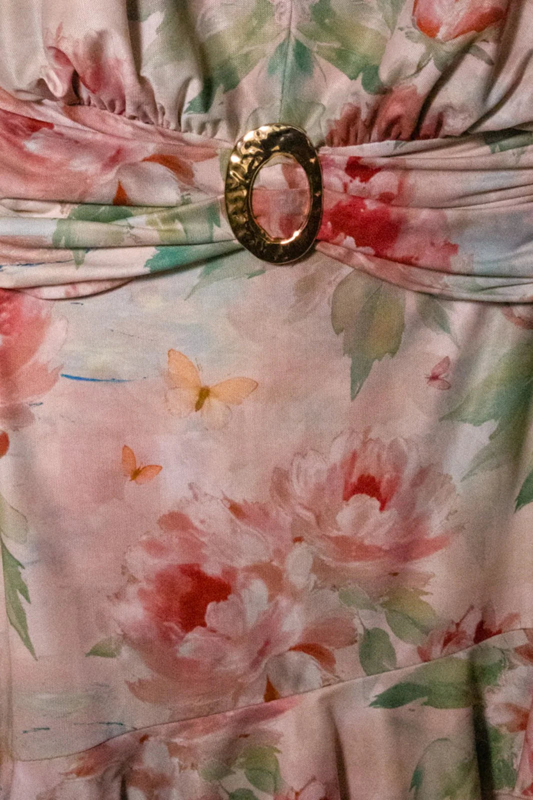 Watercolor floral ruffle halter mini dress in peach by RARA Boutique, showing the dress's flowy fabric and floral pattern.